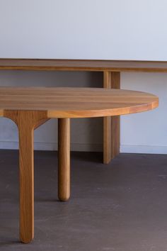 a wooden table sitting on top of a cement floor