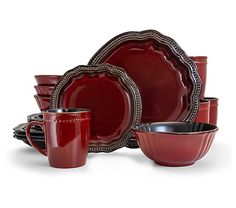 red dinnerware set with silver trimmings and black rimmed plates, cups and saucers