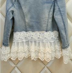 a denim jacket with white lace on the bottom