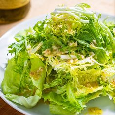 a white plate topped with lettuce and other vegetables