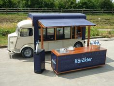 an ice cream truck parked in a parking lot next to a fenced off area