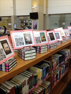 there are many books on the shelves in the library with qr - code prints