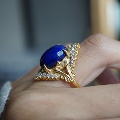 Elevate your elegance with the Heavenly Lapis Lazuli Ring, a stunning creation that marries the deep, celestial beauty of lapis lazuli with the timeless brilliance of white diamonds. The ring is adorned with a big natural lapis lazuli framed with natural white diamonds. Designed with a feminine antique frame, this exquisite ring is perfect for those who seek a blend of classic sophistication and modern allure. Crafted by skilled hands, this ring is available in your choice of 14K and 18K yellow Antique Frame, Lapis Lazuli Ring, Antique Frames, White Diamonds, 18k Rose Gold, The Deep, Lapis Lazuli, Diamond White, The Ring