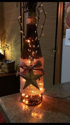 a bottle with lights in it sitting on top of a counter