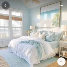 a bedroom with blue walls and white furniture