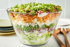 a salad in a glass bowl on top of a counter