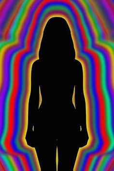 the silhouette of a woman in front of a multicolored background with swirls