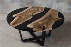 a wooden table with black metal legs and a wood slab design on the top that has been cut in half