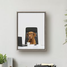 a dog with glasses sitting at a desk in front of a computer and a typewriter