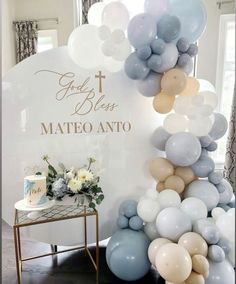 balloons are arranged on the wall in front of a sign that says god loves mateo onto