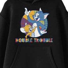 Celebrate your favorite cartoon characters with this Tom & Jerry sweatshirt. The hoodie features an image of Tom and Jerry in a colorful circle while multicolored letters below the characters read, "Double Trouble." The sweatshirt comes in black with a double-lined hood and a large pouch pocket. Fans of the Tom & Jerry cartoons will love this comfy sweatshirt. Cartoon Style Cotton Top With Letter Print, Crew Neck Hoodie With Character Print For Fans, Fun Graphic Print Hoodie Sweatshirt, Character Print Hoodie For Fans With Crew Neck, Casual Cartoon Print Sweatshirt For Fans, Fun Hoodie With Letter Print, Cotton Cartoon Style Tops With Letter Print, Fun Graphic Print Hoodie, Casual Cartoon Print Hoodie For Fans