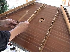 a person is playing an instrument on a table