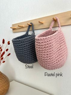 two crocheted baskets hanging on a wall