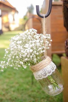 a mason jar filled with baby's breath flowers