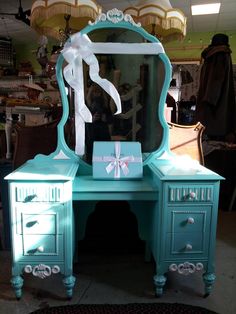 a blue vanity with a bow on it