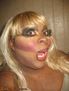 a woman with long blonde hair and makeup is posing for the camera while wearing her face painted like a clown