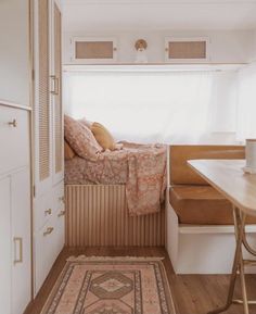 a small room with a bed and desk in it