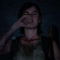 a woman with her hand on her face in the dark