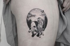 a woman's thigh with an image of a man and dog on it, in the shape of a circle