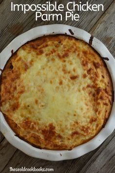 an impossible chicken parm pie in a white casserole dish on a wooden table