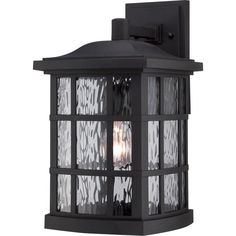 an outdoor wall light with clear glass panels on the outside and black metal trimmings