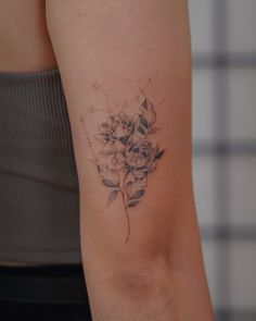 a woman with a flower tattoo on her arm