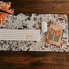 a computer keyboard sitting on top of a cowhide rug