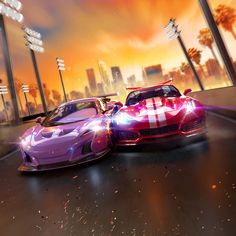 two racing cars driving down the road in front of tall buildings with lights on them