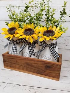 sunflowers in mason jars with gingham check ribbon tied around the top