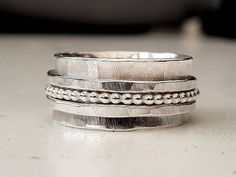 This is cool.  I have one similar to this and I love it!  It's a 1cm wide hammered silver band, stamped with a star inside ( optional) with a 1.5mm beaded silver spinner ring sandwiched between two hammered 1.5mm spinner rings. I use my favorite hammer to make these which leaves these awesome lines on the silver.  These are made to order so please let me know a ring size when ordering and allow time for making. Lexi Nails, Silver Spinner Rings, Spinner Ring, Spinner Rings, Hammered Silver, Perfect Ring, Rainbow Moonstone, Silver Band, Gold And Silver