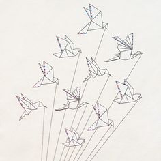 a bunch of origami birds flying in the air