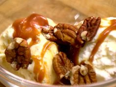 an ice cream sundae with pecans and caramel drizzle