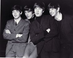 the beatles are posing for a photo together