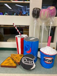 ice cream, pizza, and soda are on display in front of a store window