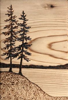 a wooden plaque with pine trees on it