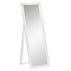 a tall white mirror sitting on top of a floor