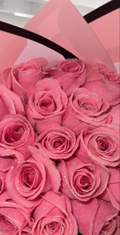 a bouquet of pink roses with water droplets on them