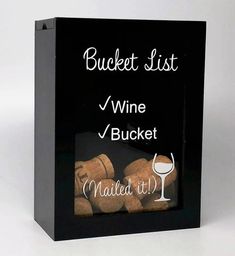 a black box with wine corks in it and the words bucket list written on it