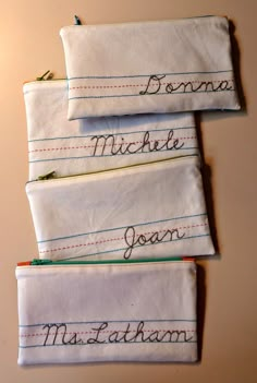 three folded towels with writing on them