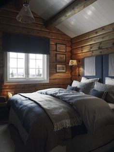 a bed in a room with wooden walls