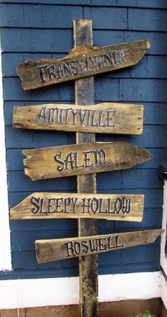 a wooden sign pointing to several different destinations