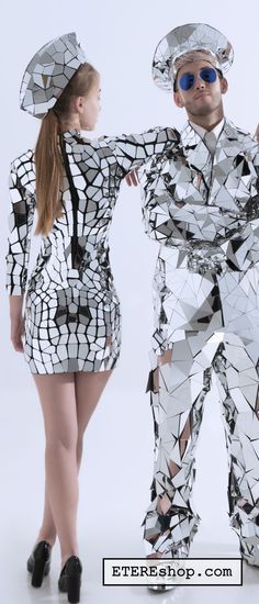 the man and woman are dressed up in futuristic clothing with mirrors on their bodys