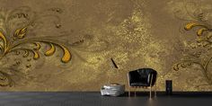 a black chair sitting in front of a wall with gold paint on it's walls