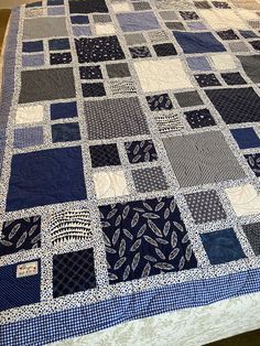 a blue and white quilt on top of a bed