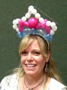 a woman wearing a balloon crown on her head