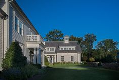 a large house sitting on top of a lush green field