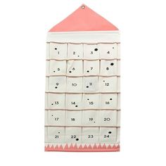 a pink and white calendar hanging from a wall with numbers on it's sides