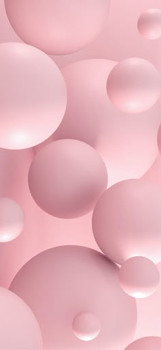 an abstract pink background with lots of bubbles in the air and on top of each other