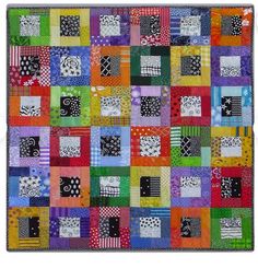 a multicolored patchwork quilt on display