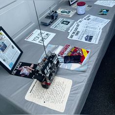 a table topped with papers and pictures on top of it